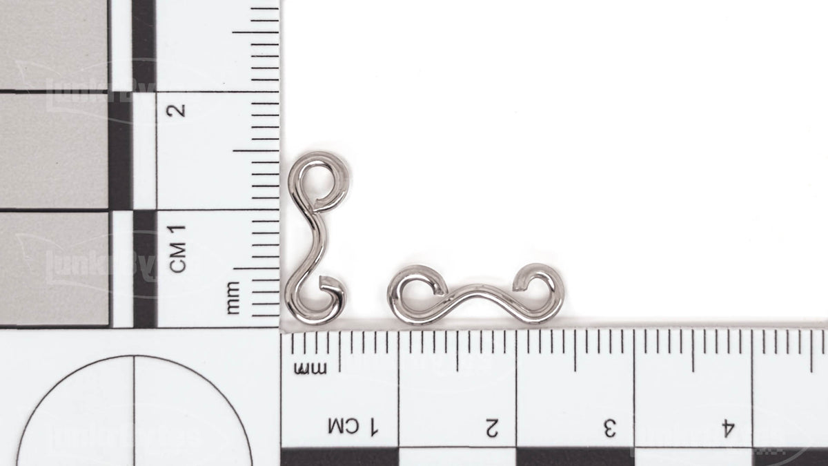 TorsiArc™ #2 Connector (LB-TorsiArc-2) on a metric ruler – about 13 mm long