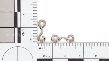 TorsiArc™ #2 Connector (LB-TorsiArc-2) on a metric ruler – about 13 mm long