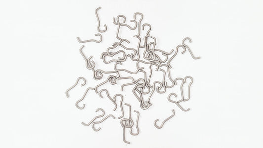 Loose pile of WEY-375 stainless steel underspin wire forms